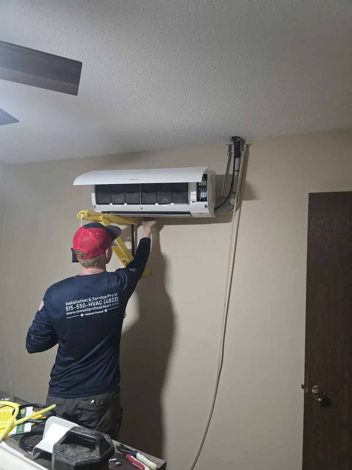 Iowa All Pro technician connecting a ductless mini-split head