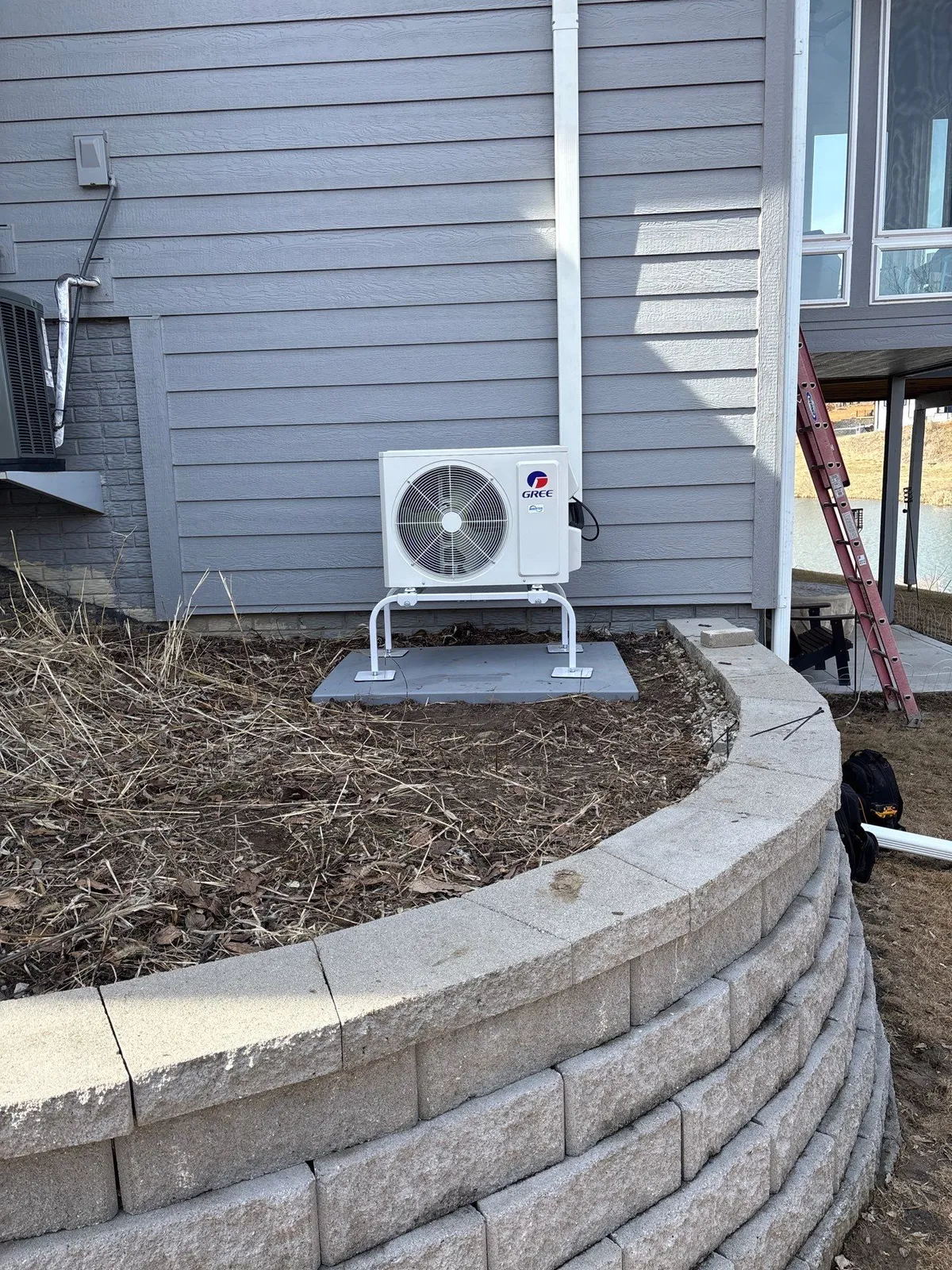 Gree air conditioning condenser unit installed outside a home