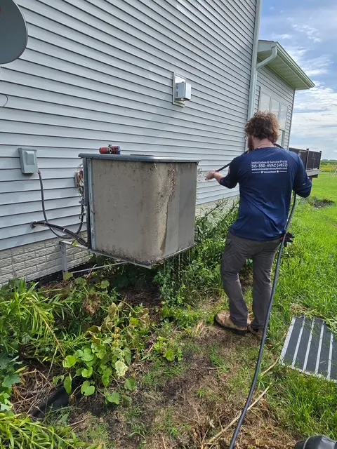 Technician Michael cleaning an air conditioning unit
