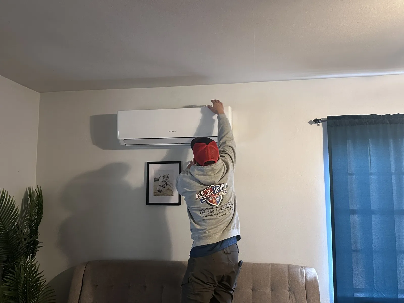 Technician Jeremiah Evans installing a Gree system