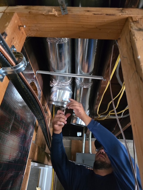 Technician building new sheet metal trunk line